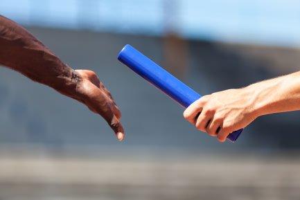 A baton being passed from one hand to the next