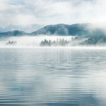 mists rising over mountain lake