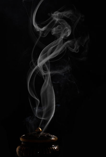 smoke rising from incense burner