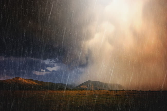 Backlit rain storm at sunset