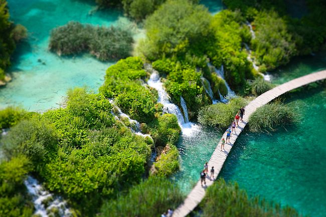 Aerial view of water flowing between two lakes