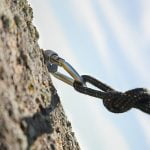 mountaineer's rope hammered into the rock face