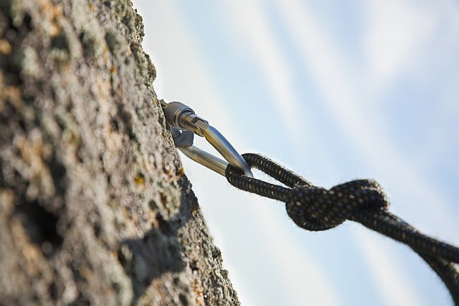 mountaineer's rope hammered into the rock face