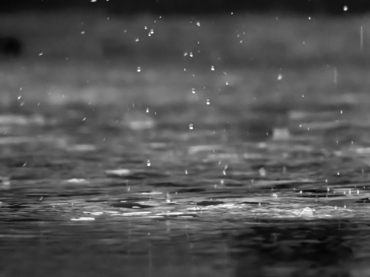 Raindrops on lake surface.