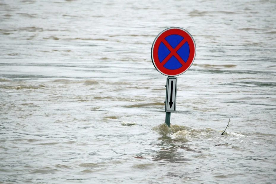 roadsign sticking up out of floodwaters